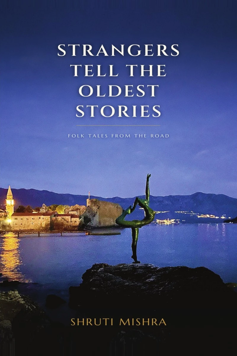 Deep-blue cover of Strangers Tell the Oldest Stories with a coastal town at night